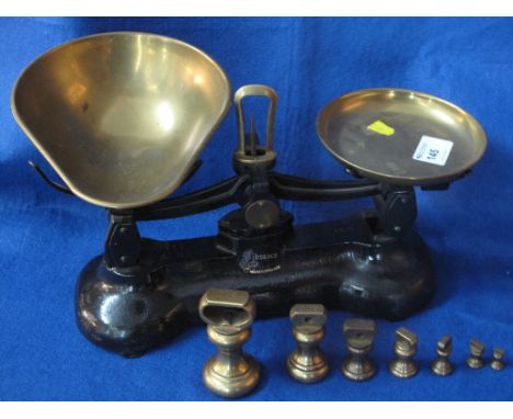 Set of "Libra" scale company cast metal and brass kitchen scales with a set of bell shaped weights.