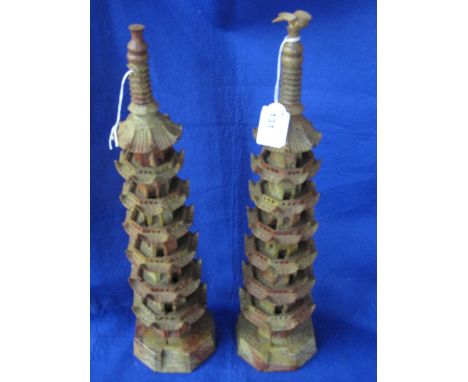 Pair of oriental soapstone pagodas of tapering form, one with perching bird to finial. 18.5" high maximum x 47". (2)