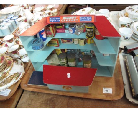 Vintage wooden miniature shop shelving display containing various food packaging and labels including soap flakes, Coleman's 