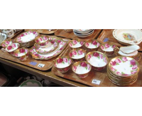 Two trays of Royal Albert Crown china on a white ground decorated with roses comprising cups, saucers, plates, milk jug, sucr