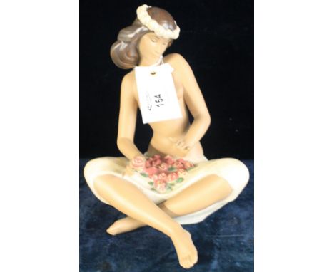 Nao porcelain figure of a seated semi nude female flower arranging, impressed and printed marks to base, boxed.