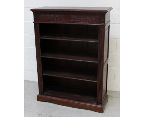 A carved oak three-shelf bookcase, width 90cm.