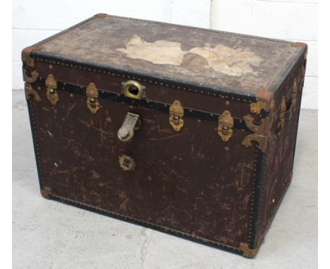 A brass-bound studded travel trunk, width 92cm.