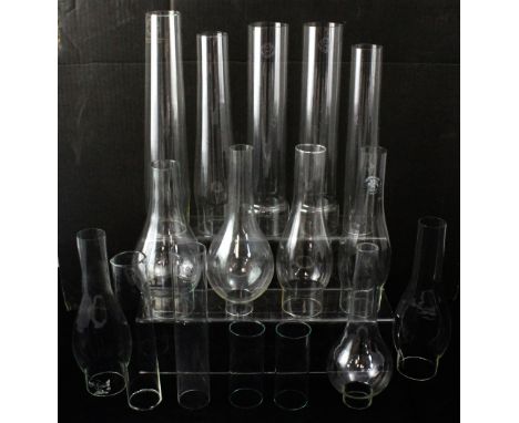 Sixteen glass paraffin lamp chimneys in various shapes, height of largest approx 33cm (16).