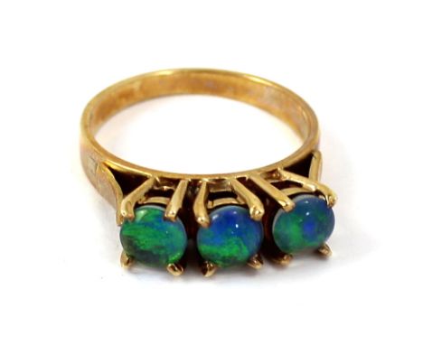 A 9ct gold ladies' dress ring set with three black opals, size N, approx 3.9g. CONDITION REPORT Black opal - https://geology.