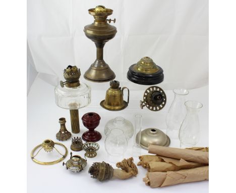 A collection of oil lamps to include a brass example with fluted column, height 52cm, also a brass carriage lamp.