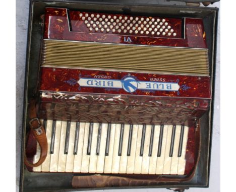 A Bluebird Super Organ piano accordion with mother of pearl effect keys to a deep red and yellow marbled ground, width 44cm, 