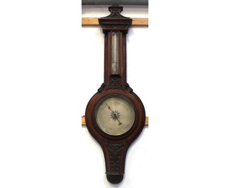 A Victorian carved mahogany aneroid barometer and thermometer, length 98cm.
