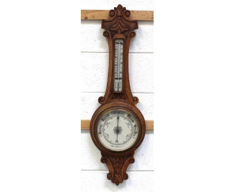 An early 20th century oak aneroid barometer and thermometer, length 88cm.