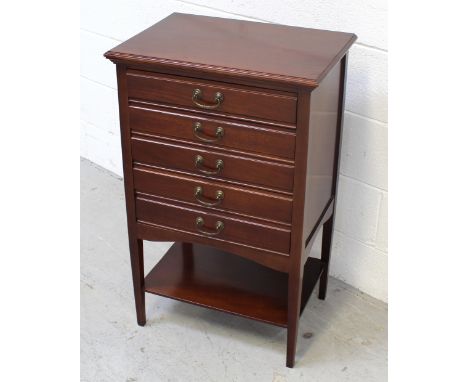 A reproduction mahogany five-drawer music cabinet with one lower shelf, height 84cm.