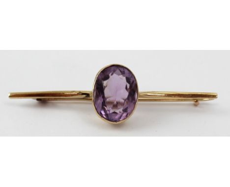 An Edwardian 9ct gold bar brooch set with central oval faceted amethyst, approx 4.1g. CONDITION REPORT There are some small c
