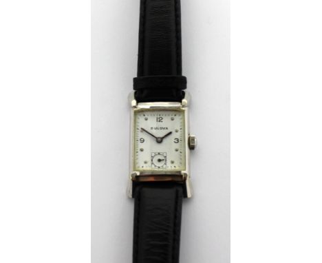 Bulova; a 1946  'Ambassador' Art Deco tank-style watch, 10K white gold filled rectangular case with extended lugs, the white 