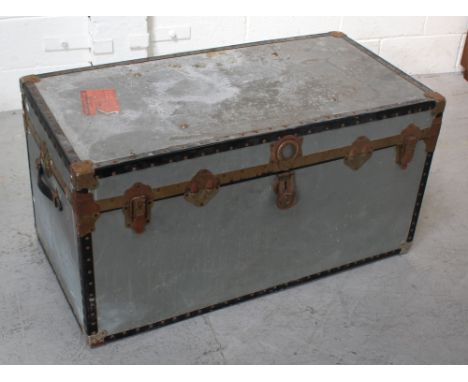 A vintage metal travel trunk with travel labels, length 100cm.