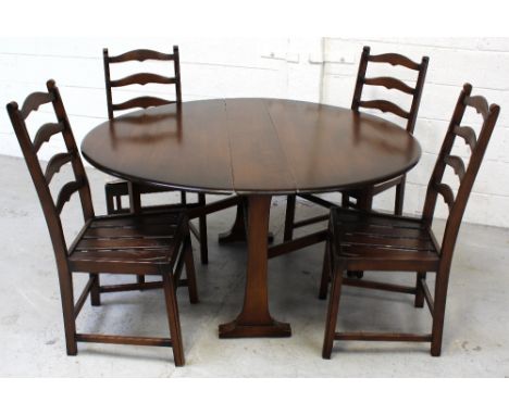 An Ercol oak 'Old Colonial' drop-leaf dining table, length 133cm and a set of four matching 'Old Colonial' ladder-back dining