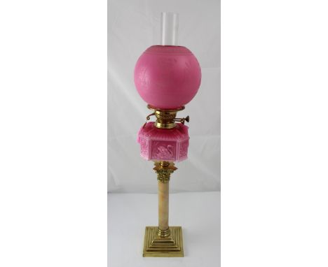 A brass and marble-effect oil lamp with pink swan decorated font and embossed globe, height 82cm. CONDITION REPORT No obvious