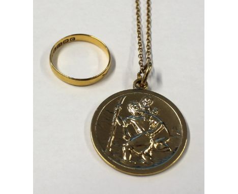 A 22ct gold ladies' wedding band, size M 1/2, approx 2.1g and a yellow metal St Christopher pendant on a yellow metal link ch