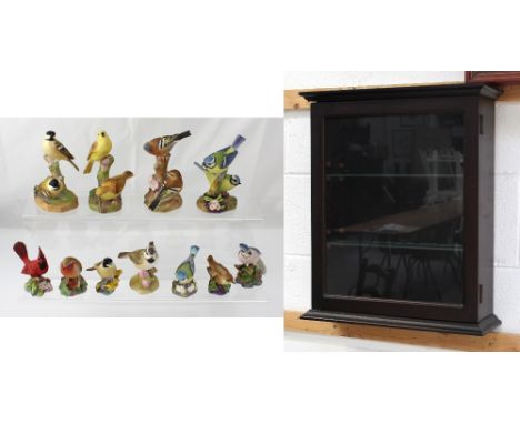 A glazed wall-hanging display cabinet and eleven Royal Worcester bird figures to include yellowhammer, blue tit, robin, red c