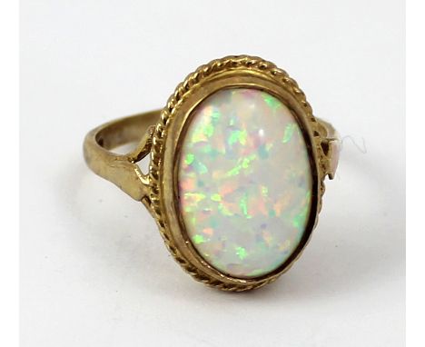 A 9ct gold ladies' dress ring set with a single oval opal, size M 1/2, approx 3.1g.