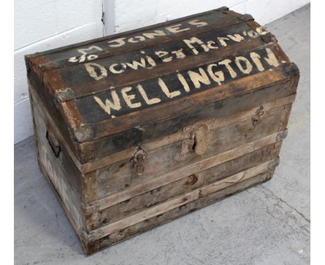 A late 19th/early 20th century wood and canvas travel trunk with dome top, 'M Jones Downeys Wellington', length 69cm.