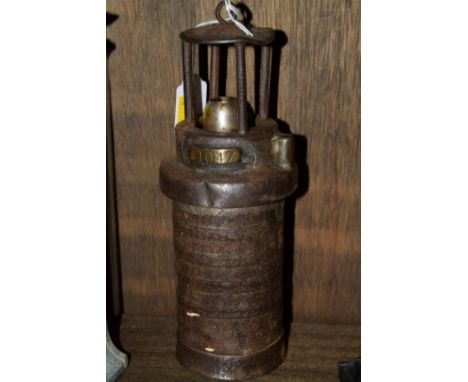 An old steel miner's lamp, indistinctly inscribed to the base 'Mine Supply Company, Barnsley', and numbered on brass plaque 1