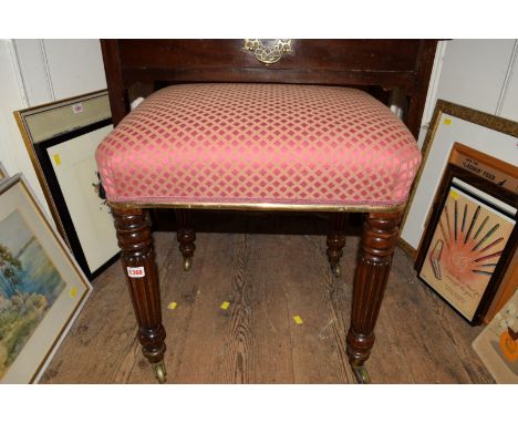 A mahogany and upholstered rectangular stool, stamped Gillows, on reeded legs with brass caps and casters.   Condition Report