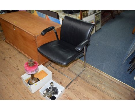 A pair of vintage style black leather and chrome armchairs. 