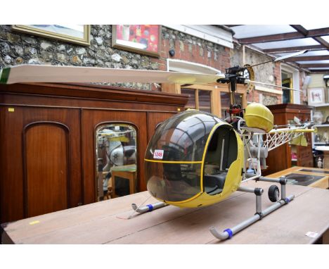 A vintage radio controlled helicopter, approx 142cm long, (lacking radio controller). 