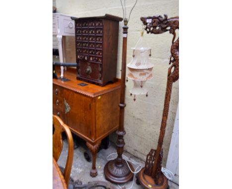 An old carved walnut standard lamp.