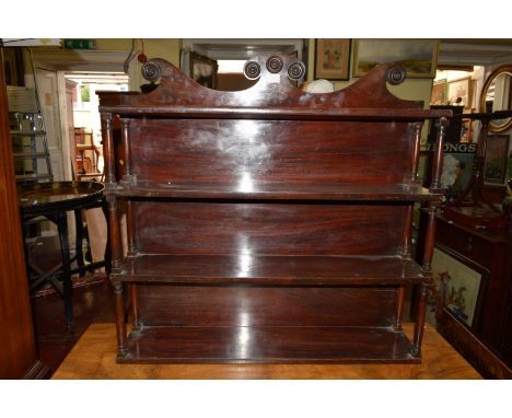 A George IV mahogany four tier hanging wall shelf, 84cm wide. 