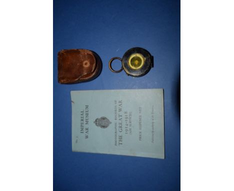 A World War I period pocket compass, in leather case; together with Imperial War Museum booklet. 