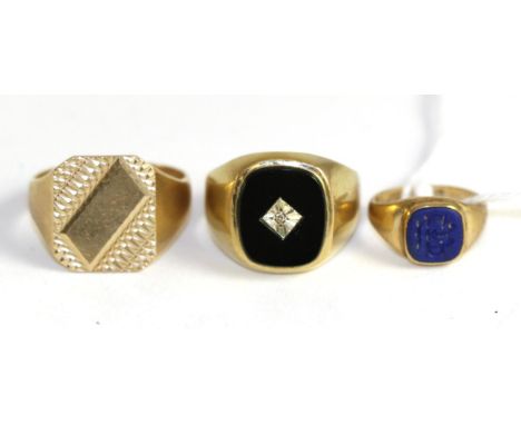 A 9ct gold lapis lazuli intaglio signet ring, finger size F, a 9ct gold onyx and diamond signet ring, finger size S and a 9ct