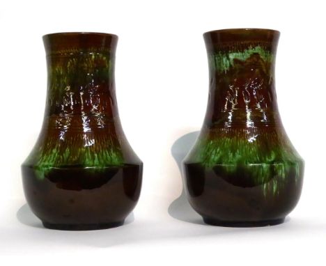 Christopher Dresser for Linthorpe Pottery: Two Vases, shape No.60, decorated with a repeating pattern, covered in a green and