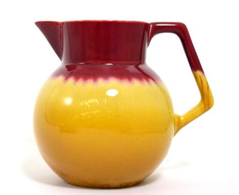 Christopher Dresser for Linthorpe Pottery: A Jug, shape No.783, mustard and deep pink glaze, impressed LINTHORPE Chr Dresser 