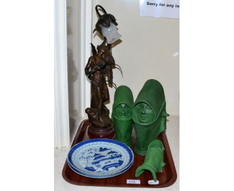 Two blue and white Chinese plates, three art pottery green heads, a Spelter table lamp and a brass four branch light fitting 