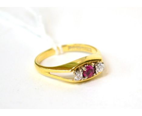 An 18ct gold ruby and diamond ring three stone ring, total estimated diamond weight 0.10 carat approximately, finger size N1/