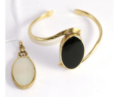 A 9ct gold onyx set bangle and a 9ct gold onyx and mother-of-pearl pendant (2)31.2g gross