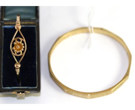 A 9ct gold bangle, and another bangle with floral motif (2)21.24g gross