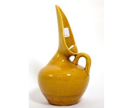 Christopher Dresser for Linthorpe Pottery: A Jug, shape No.346, moulded with repeating designs, mustard glaze, impressed 346,