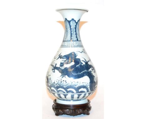 A Chinese porcelain bottle vase, underglaze dragon chasing flaming pearl, six character marks to base, 25cm in height