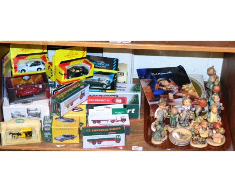 A collection of Goebel figures, together with some boxed model vehicles