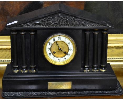 A black slate striking mantel clock 