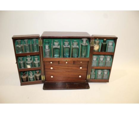 19THC APOTHECARY MEDICINE CABINET &amp; CONTENTS a fitted mahogany cabinet with a variety of glass bottles. With three small 