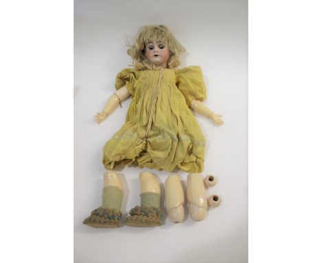 BISQUE HEAD GERMAN DOLL probably by Heinrich Handwerck, with weighted brown eyes, open mouth and pierced ears. The body and l