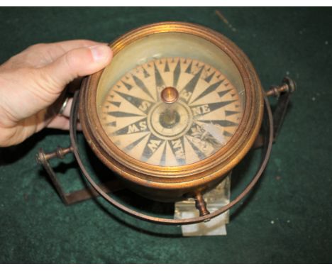 NAVAL GIMBAL COMPASS a gimbal compass with a metal case and metal fixing underneath. Dial 12cms diameter