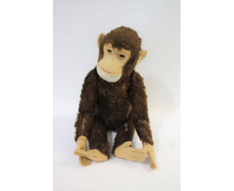 LARGE CLOCKWORK MONKEY possibly by Steiff or Schuco, with glass eyes and a head that moves from side to side. Wound from the 