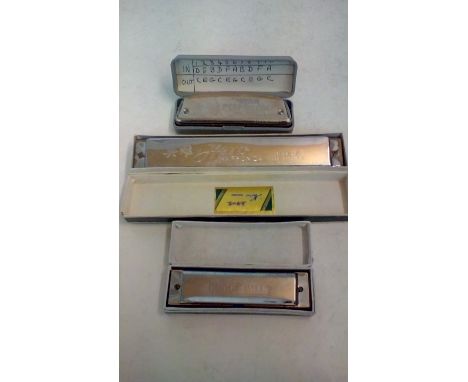 Three vintage  harmonicas, each with case