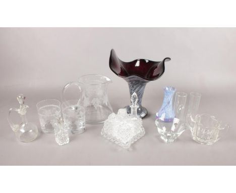 A box of assorted glassware. To include a Caithness vase, a handkerchief style vase, and an etched glass jug with matching tu