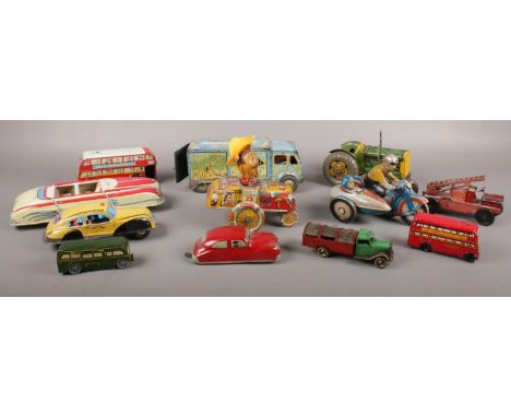 A group of 12 tin plate toys, Marx Crazy Cowboy, Tri- Ang, Met-toy tractor etc  