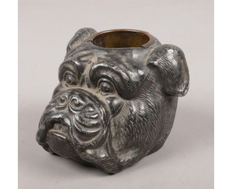 A vintage metal match strike in the form of a bulldog.  