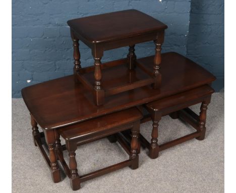 An Ercol Old Colonial nest of three tables. Comprising of coffee table and two smaller occasional tables along with other mat